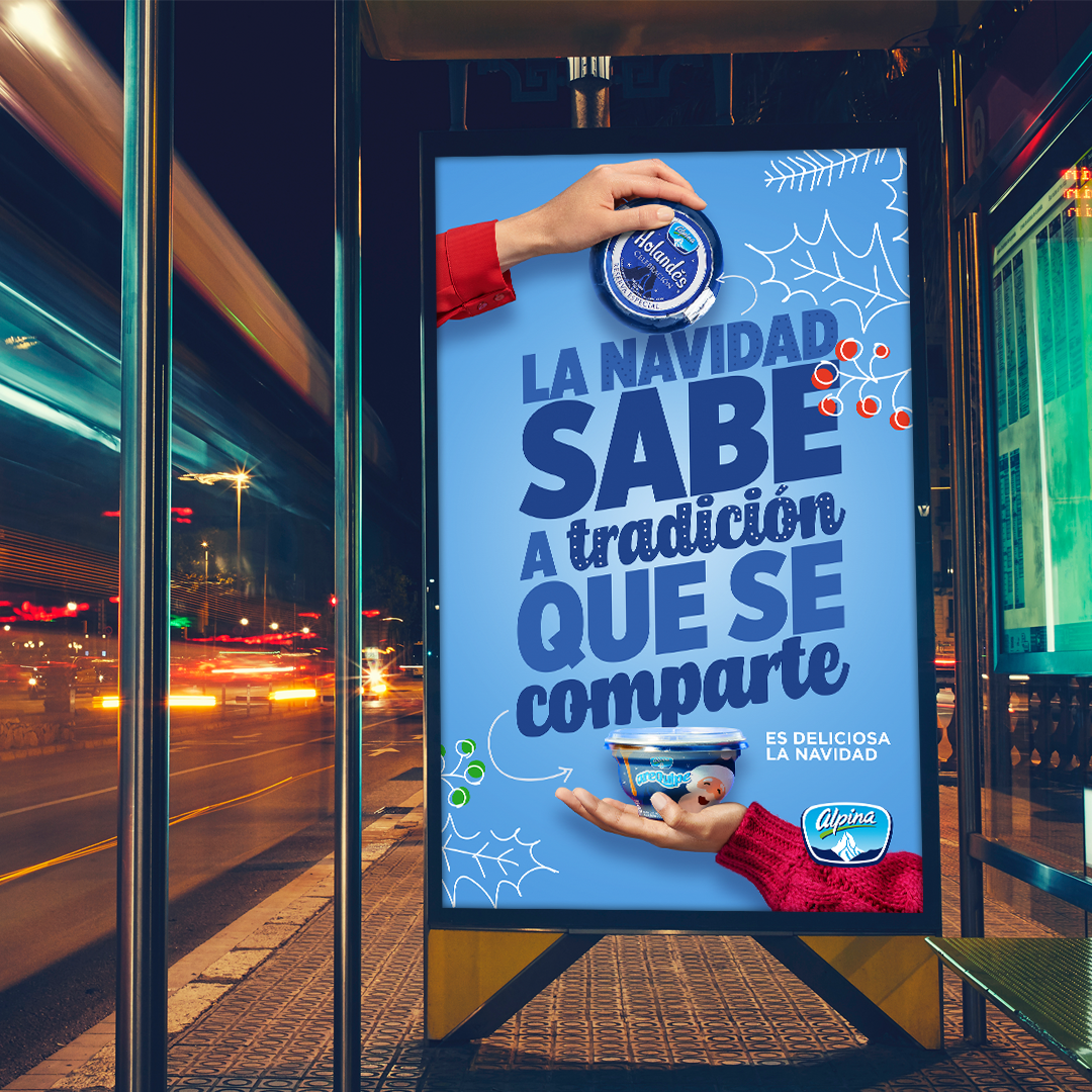 Alpina Arequipe — backlit bus stop mupi at night. La navidad sabe a tradición que se comparte