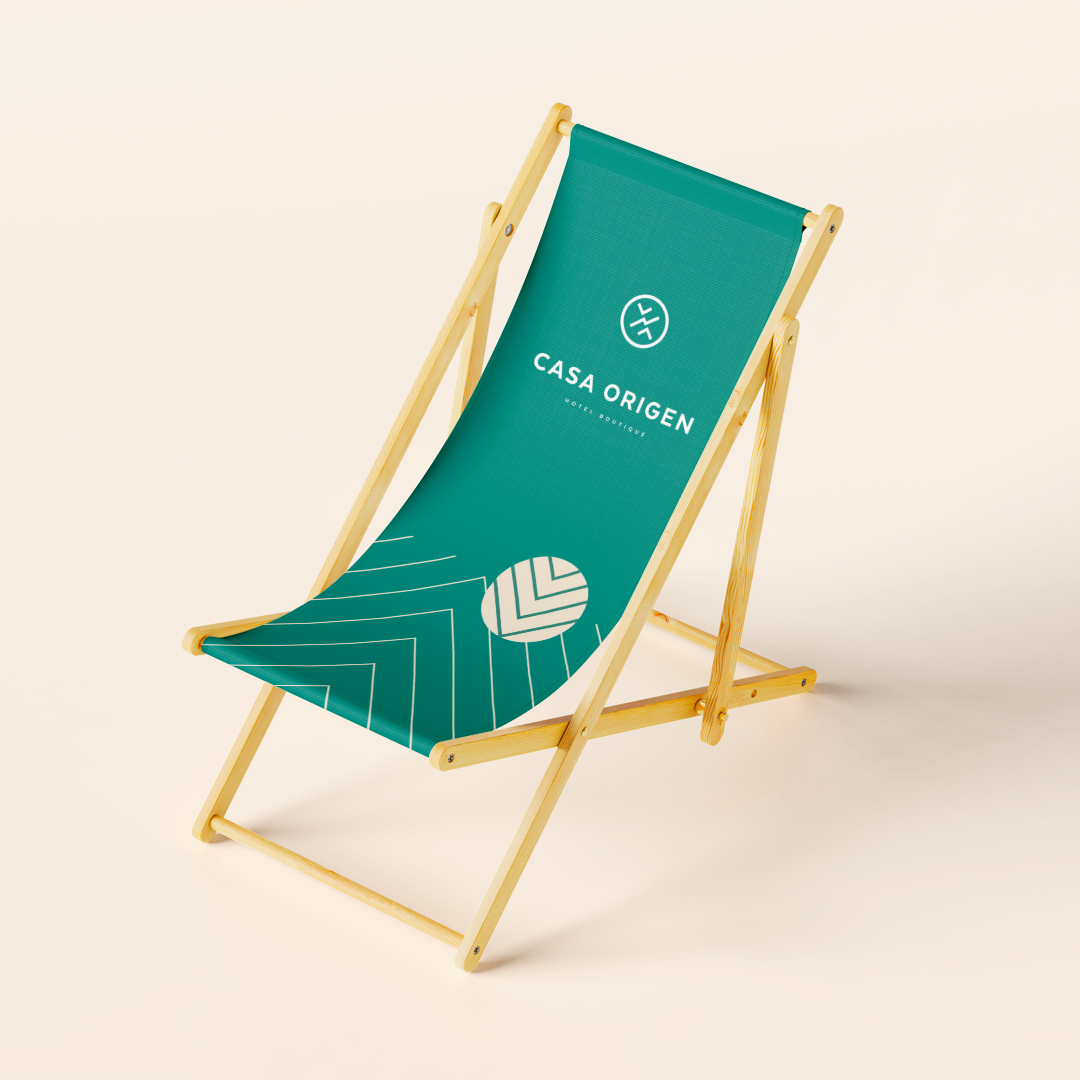 Casa Origen branded beach chair — teal on sand